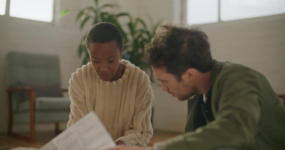 A man and woman working together on a piece of furniture