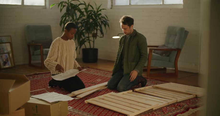 A man and woman assembling furniture together
