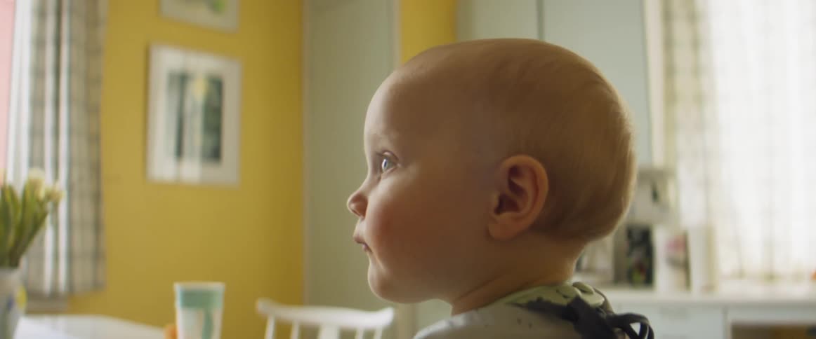 A baby that is sitting in a kitchen