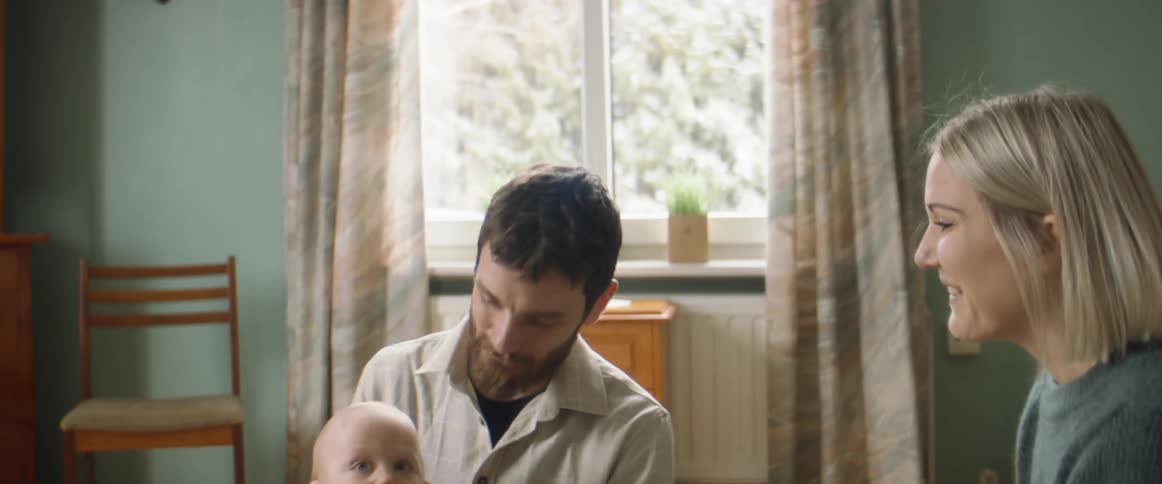 A father and mother playing with a child