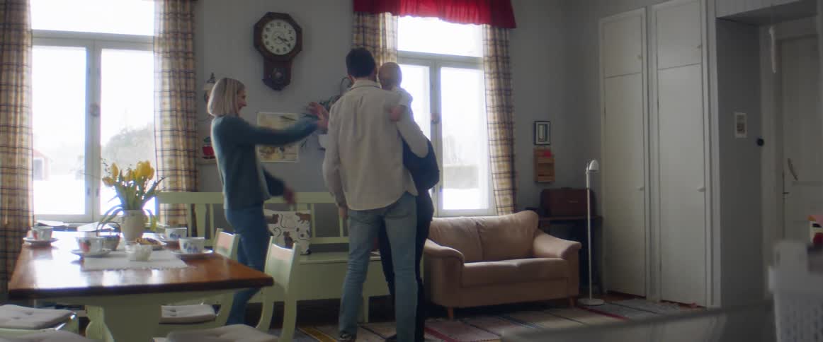 A mother and father taking their infant to see their grandmother