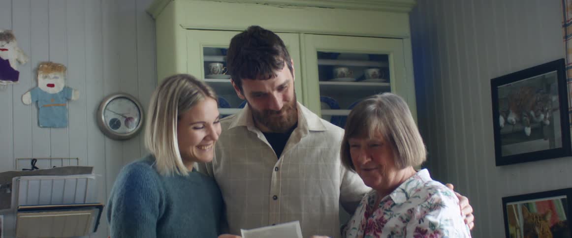 Parents to be share ultrasound picture with grandmother to be