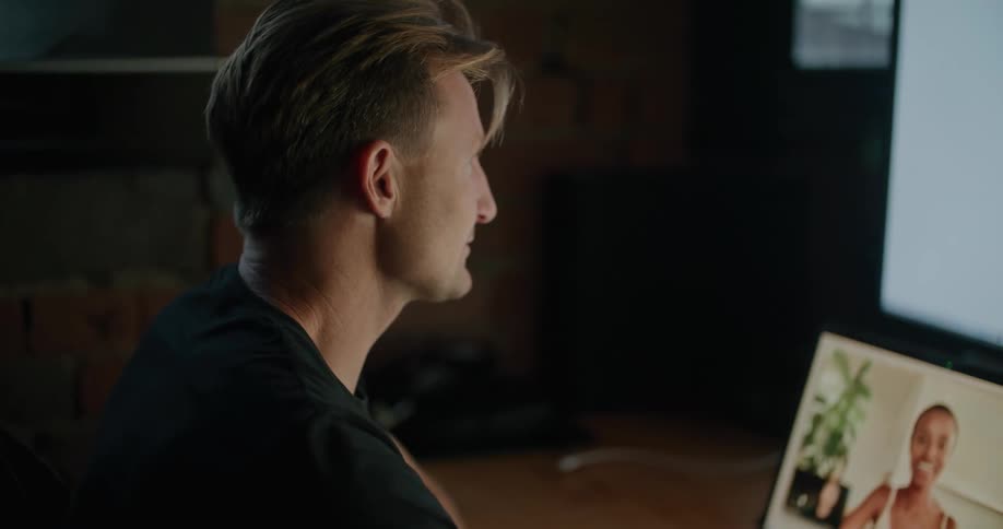 A man and woman talking on a laptop with webcams