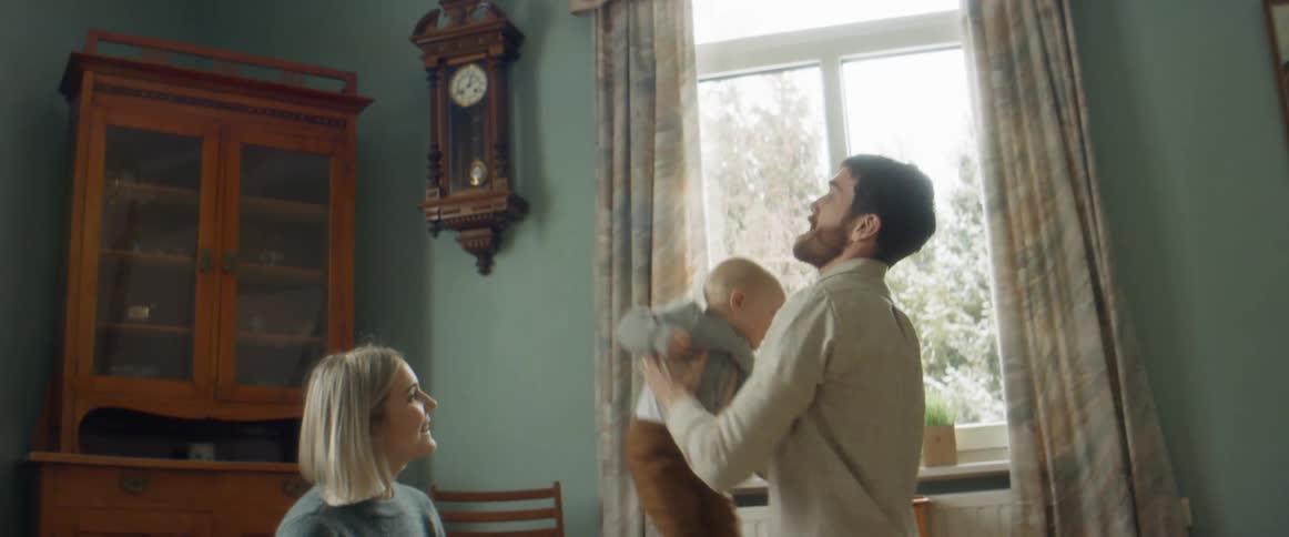 A father and mother playing with a child