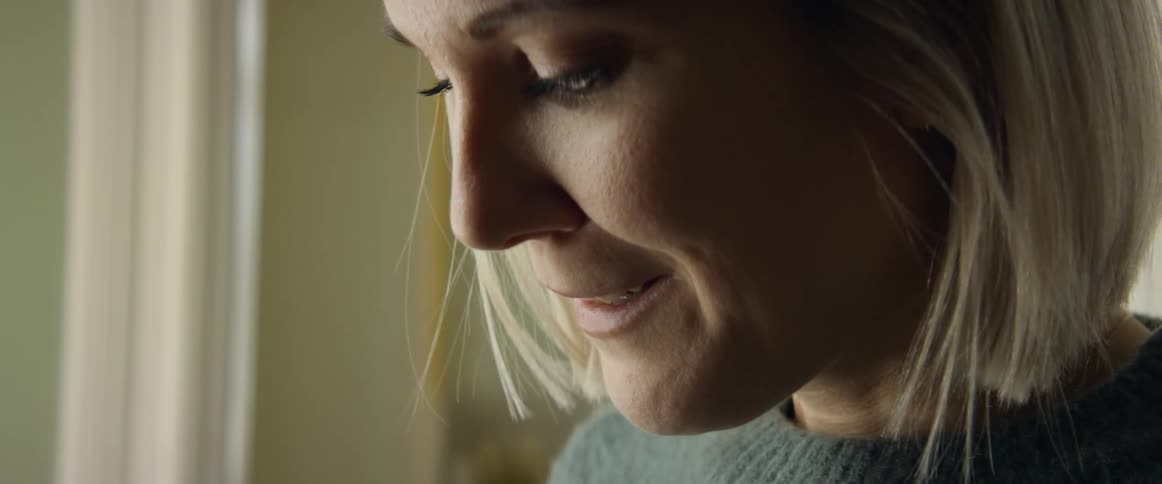 A woman grabbing her mouth and crying