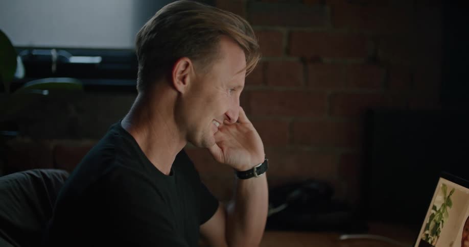 A man talking to a woman on a computer