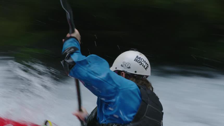 Real time handheld shot of a man paddling straight towards and past camera in this high energy action adventure shot