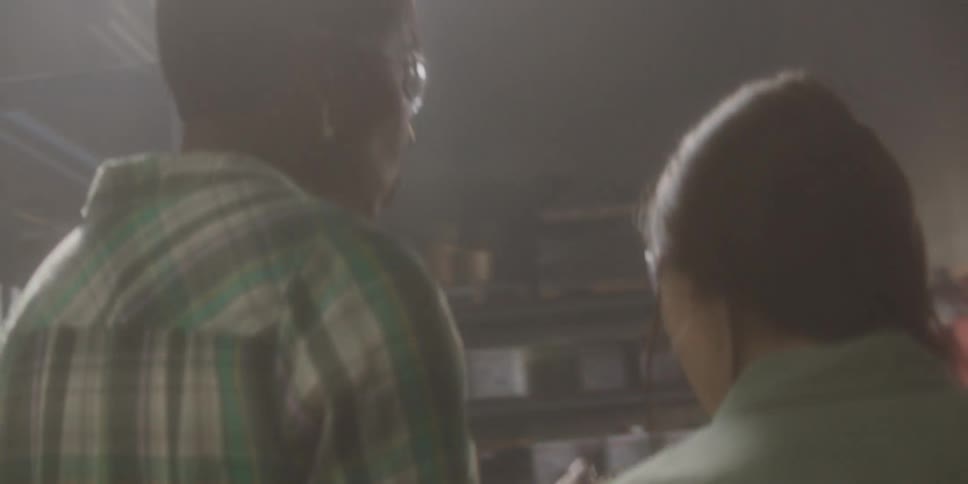 Two coworkers walking around in a warehouse