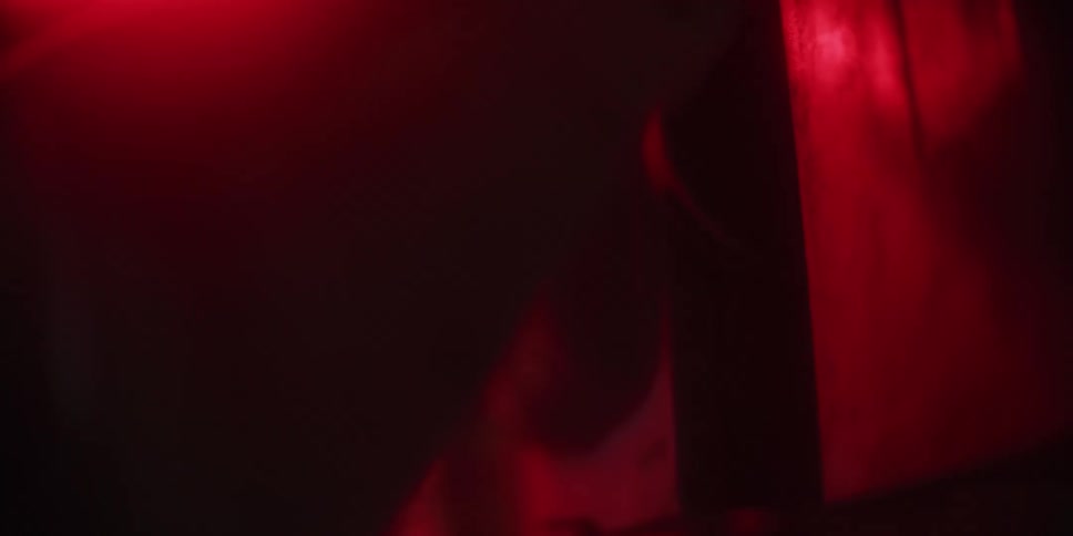 A person in a room pushing a switch