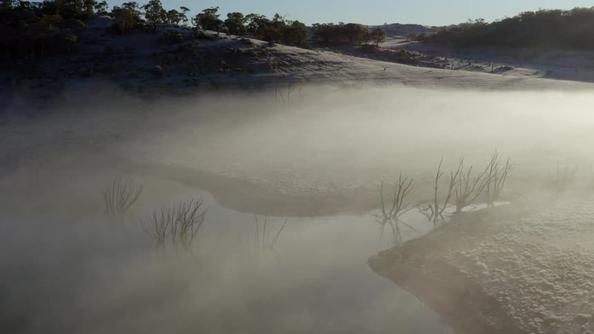 Mist floating above a body of water in nature