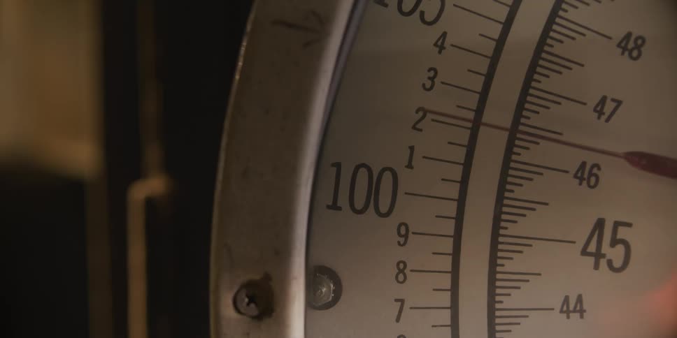 A gauge with numbers and a needle