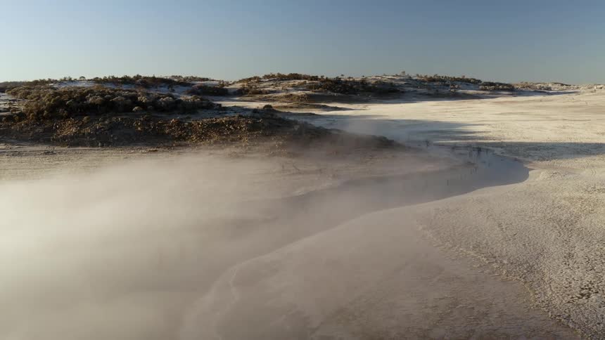 An aerial view of hills and snow