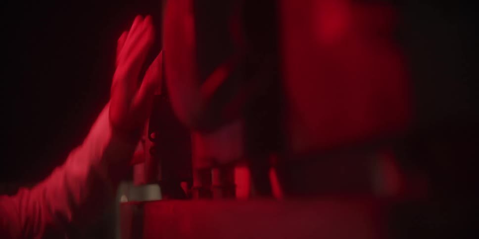 A person in a room pushing a switch