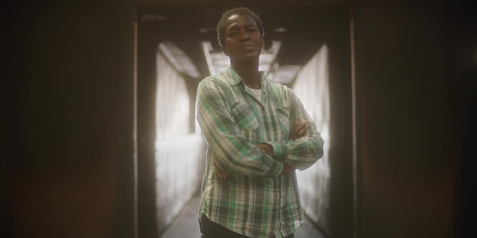 A portrait of a person in a hallway