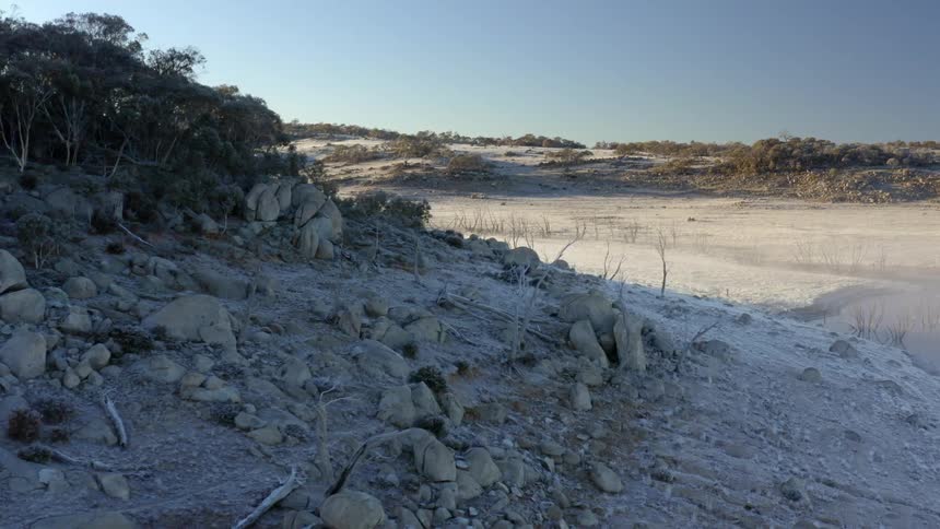 Small rock covered hills dot the landscape at a beach