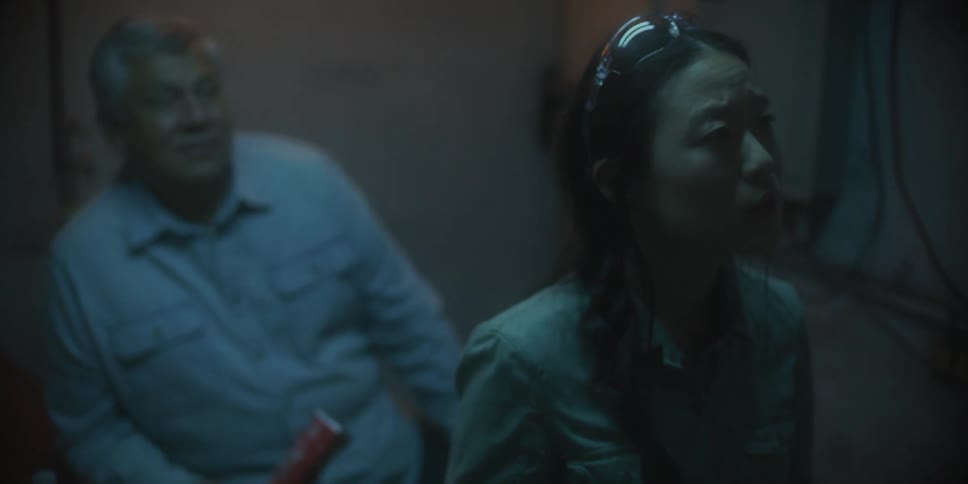 Two people sitting next to each other in a room