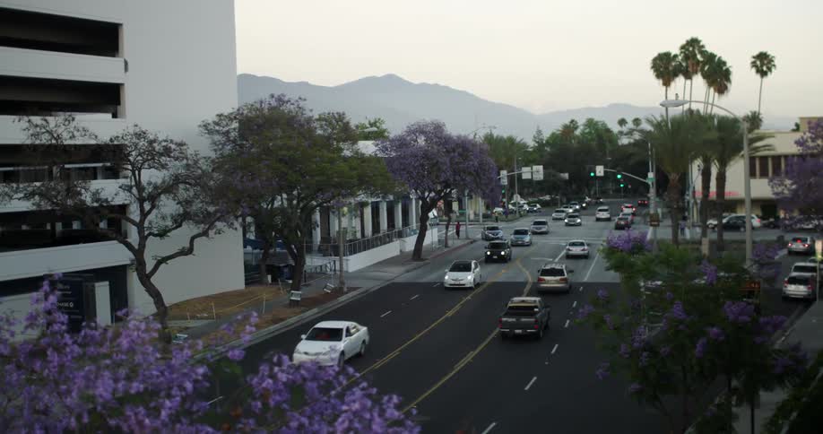 Vehicles in a city near a mountain in the morning