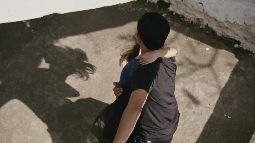A man and woman dancing outside