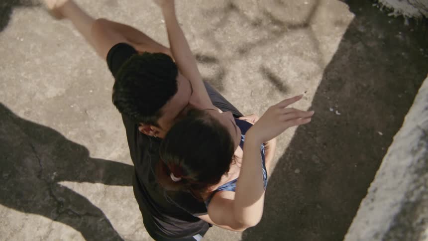 A male and female dancing and spinning outside