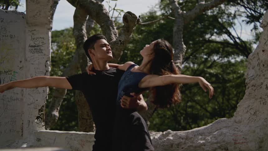 A man and woman dancing outdoors