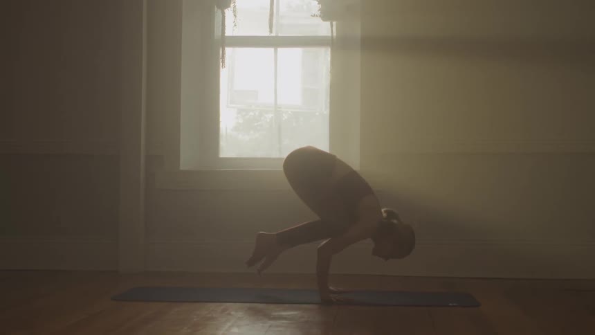 A woman doing yoga in a room