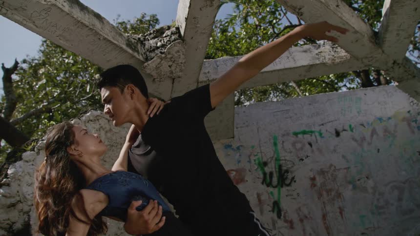 A male and female ballet dancer dancing outside