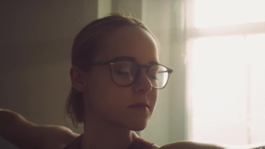 A woman stretched her arms while keeping her eyes closed