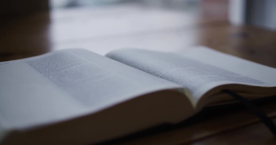 A bible lies on a wooden table