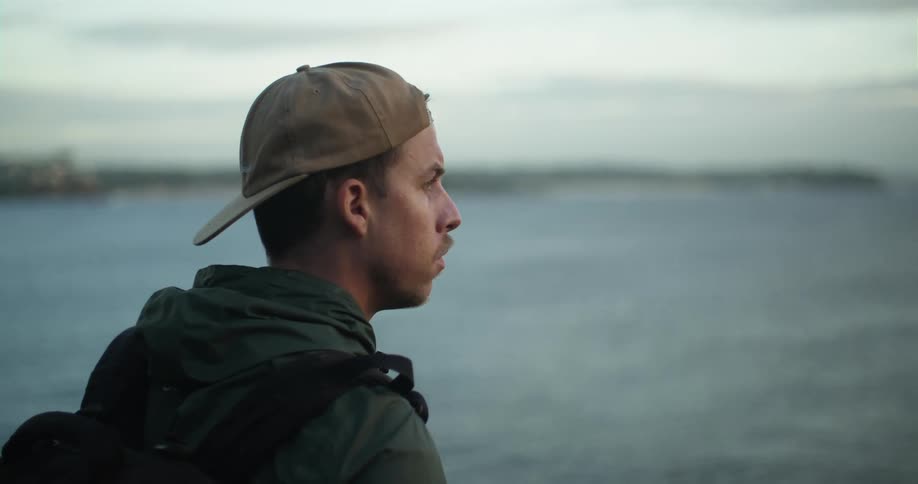 A man looking out into the distance at the ocean