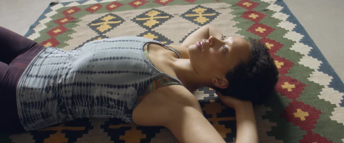 A woman laying on a rug