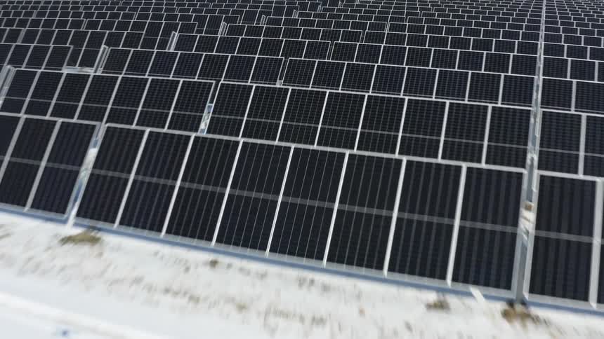 Aerial view of rows of black solar panels