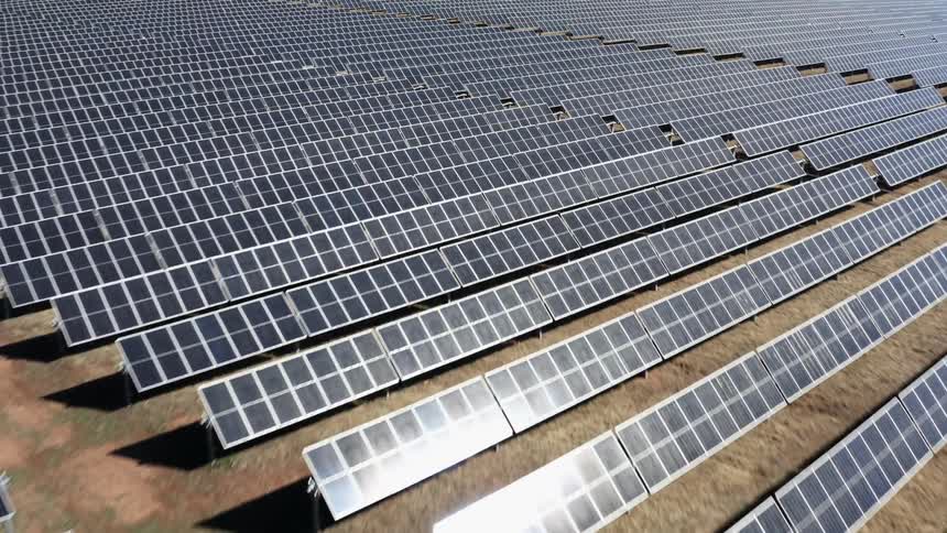 Rows of solar panels on a solar farm during the day
