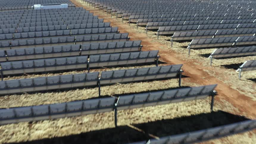 Rows of solar panels on a solar farm during the day