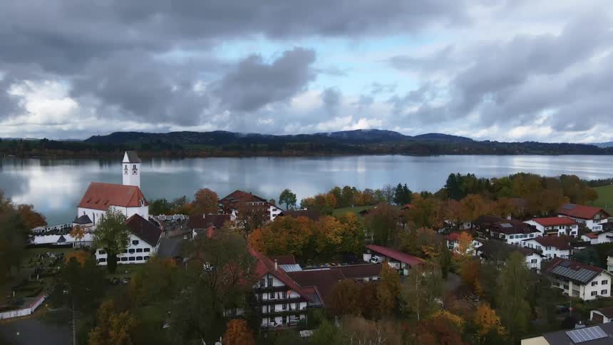 An aerial view of a small town next to a lake on an overcast day