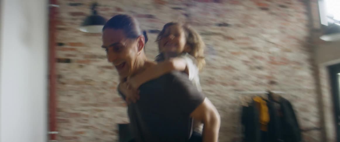 A father and son run around the house