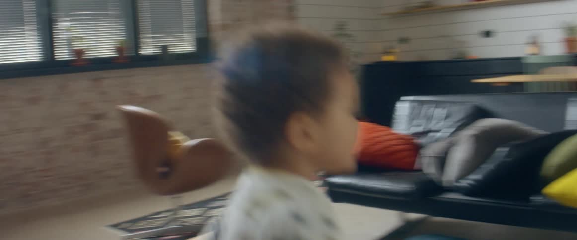 Two little brothers run around a house together