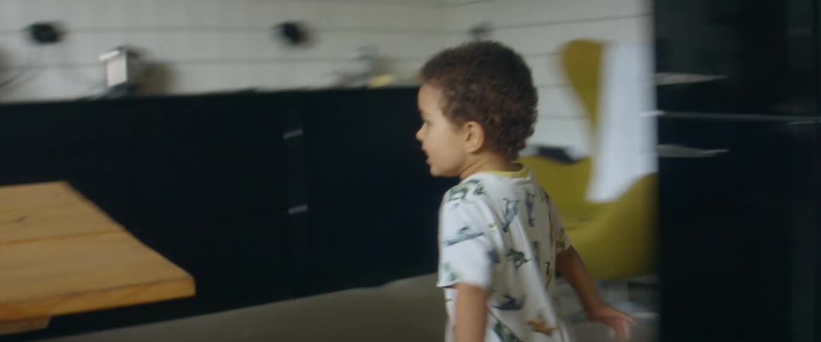 Children and parents chase each other around the kitchen table