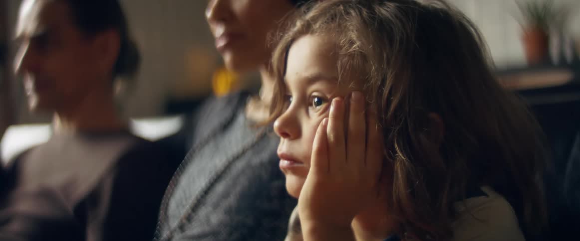A family sits at home and watches a show