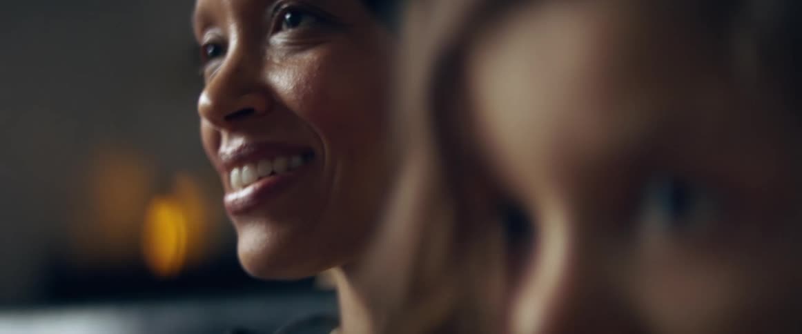 A portrait of a smiling woman and concerned looking child