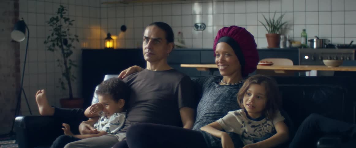 Family relaxing together sitting on the couch at home