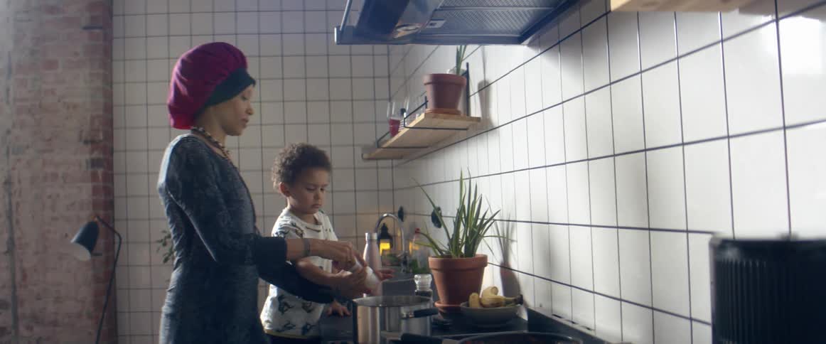 Mother and son cooking in the kitchen at home