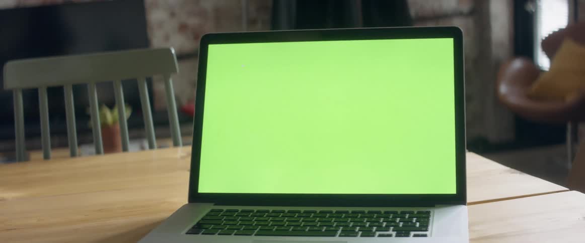 A person typing on a laptop on a table