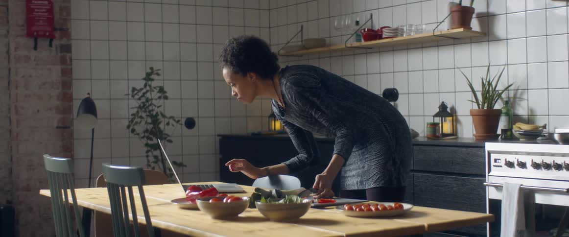 A woman cooking food in a kitchen