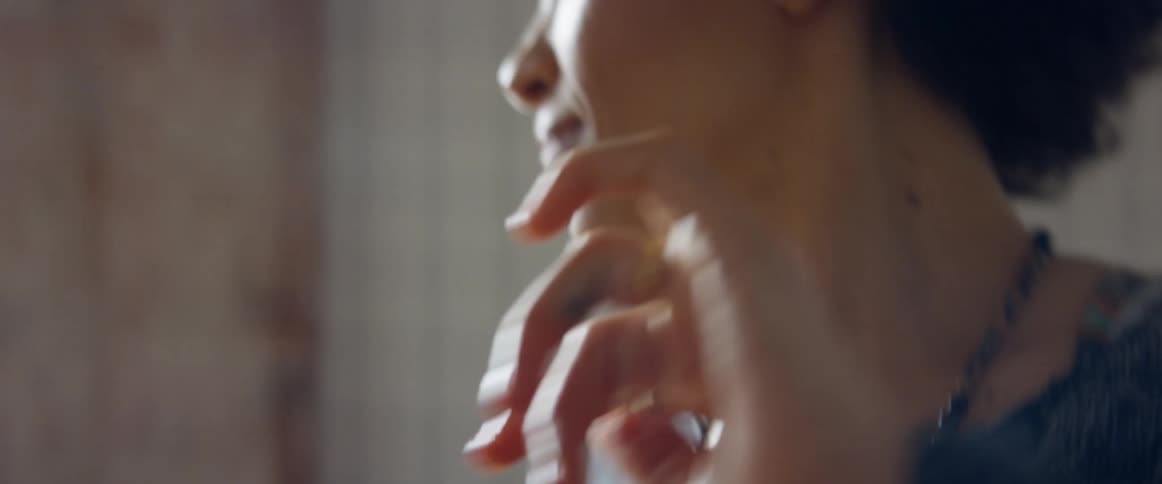 A woman in a room dancing with walls and windows in the background