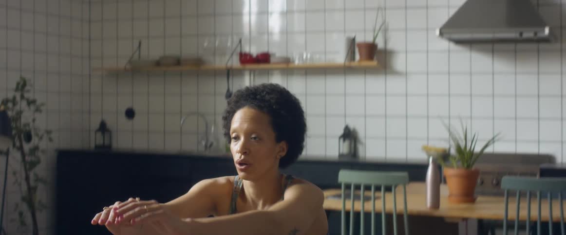 A woman doing squats in a room