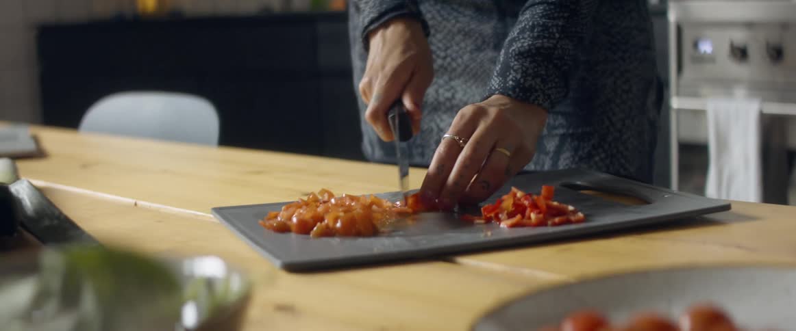 A woman chopping vegetables at home