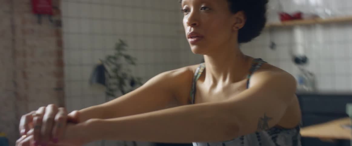 Woman wearing sports clothes exercises on the living room at home