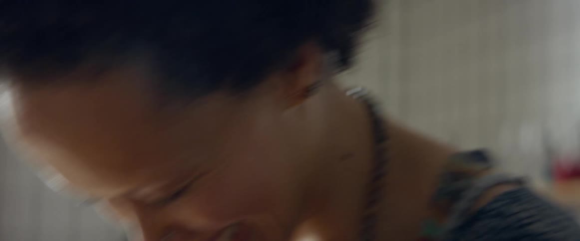 A woman laughing hard in a room