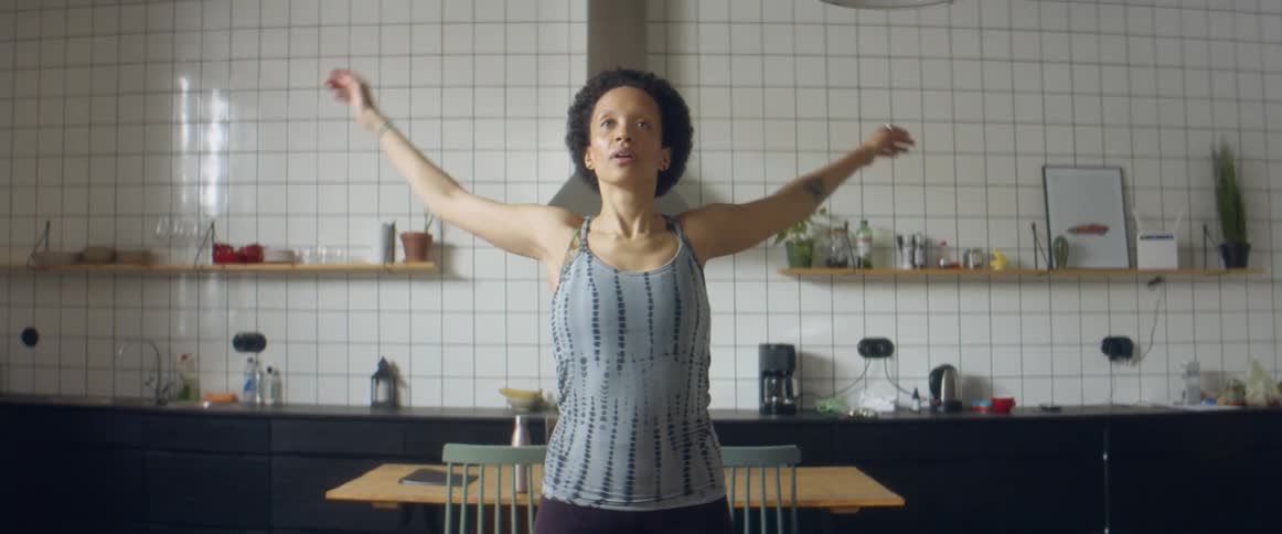 A woman stretches at home