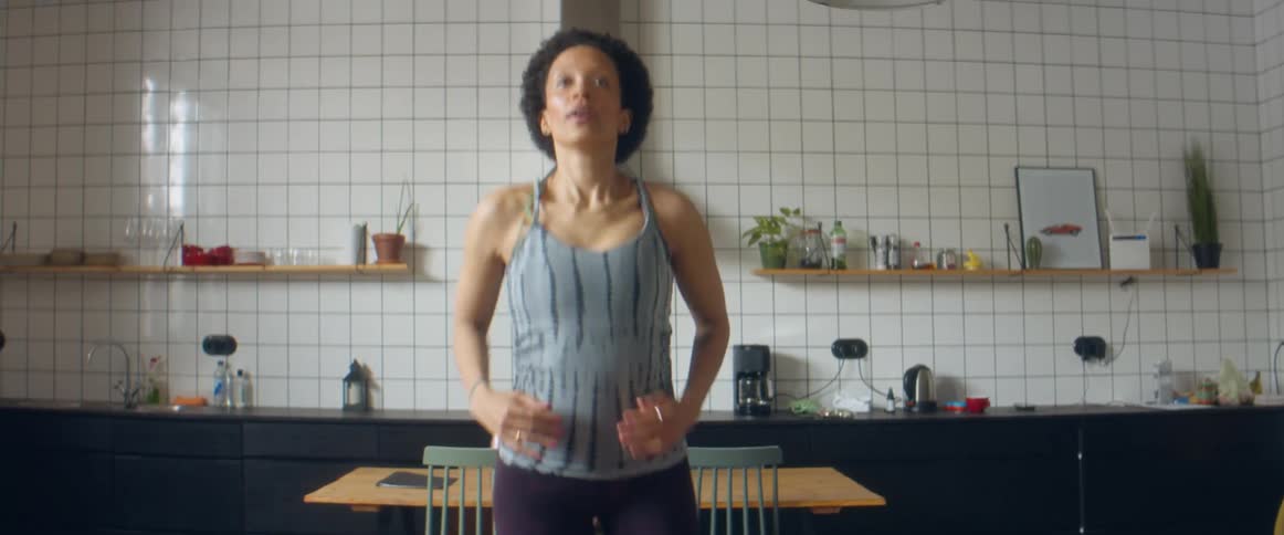 A woman running in place while doing a home workout